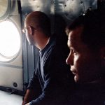 Aboard a helicopter on a US military mission to retrieve the bones of US servicemen shot down during the Vietnam War. Seth Meixner and Kevin Doyle.